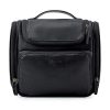 Hanging Toiletry Bag is a large, leather travel organizer that is waterproof and perfect for storing full-sized containers, toiletries, brushes, and shaving items. It is suitable for both men and women and comes in black color. The bag's hanging design makes it easy to access and use your toiletries while traveling.