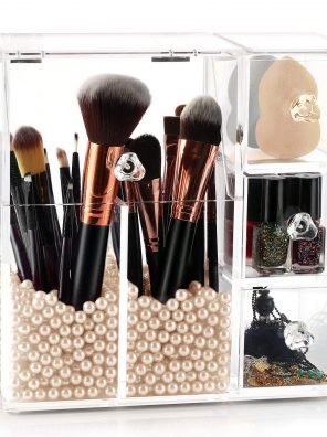 A chic acrylic makeup brush holder with a dustproof lid, pink pearl beads, and two compartments for storing brushes and beauty essentials.